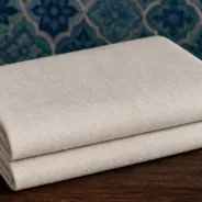 KashiFab Banarasi Pure Matka Silk folded on table - Banaras fabric cover