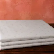 KashiFab Banarasi Pure Munga Zari Meena Buti folded on table - Banaras fabric cover
