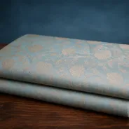 KashiFab Banarasi Pure Munga Zari Meena Buti folded on table - Banaras fabric cover