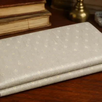 KashiFab Pure Resham Spun Meena Brocade folded on table - Banaras fabric cover