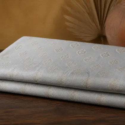 KashiFab Pure Resham Spun Meena Brocade folded on table - Banaras fabric cover