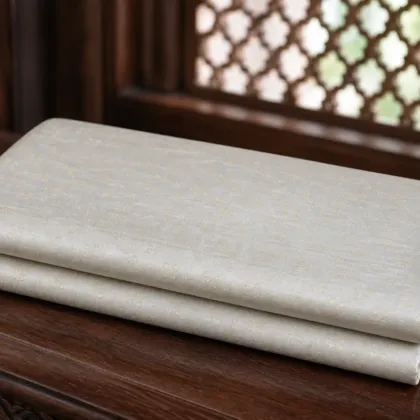KashiFab Pure Resham Spun Meena Brocade folded on table - Banaras fabric cover