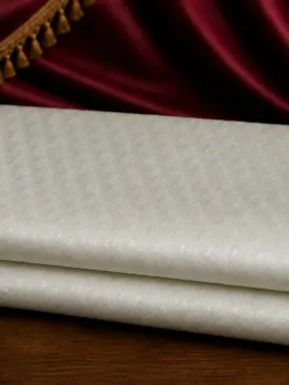 KashiFab Pure Resham Spun Meena Brocade folded on table - Banaras fabric cover