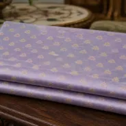 KashiFab Pure Resham Spun Meena Brocade folded on table - Banaras fabric cover