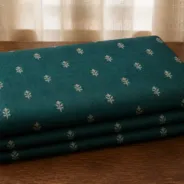 KashiFab Banarasi Pure Raw Silk Zari Booti folded on table - Banaras fabric cover