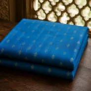 KashiFab Banarasi Pure Raw Silk Zari Booti folded on table - Banaras fabric cover