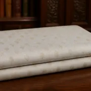 KashiFab Banarasi Pure Raw Silk Zari Booti folded on table - Banaras fabric cover