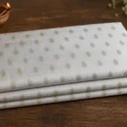 KashiFab Banarasi Pure Raw Silk Zari Booti folded on table - Banaras fabric cover