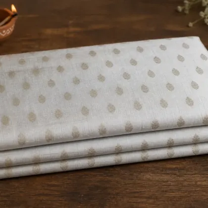KashiFab Banarasi Pure Raw Silk Zari Booti folded on table - Banaras fabric cover