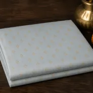 KashiFab Banarasi Pure Resham Cotton Meena Jacquard folded on table - Banaras fabric cover
