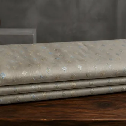 KashiFab Banarasi Resham Zari Meena Brocade folded on table - Banaras fabric cover