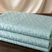 KashiFab Banarasi Resham Zari Meena Brocade folded on table - Banaras fabric cover