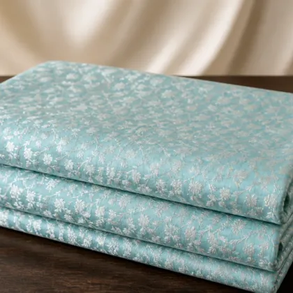 KashiFab Banarasi Resham Zari Meena Brocade folded on table - Banaras fabric cover