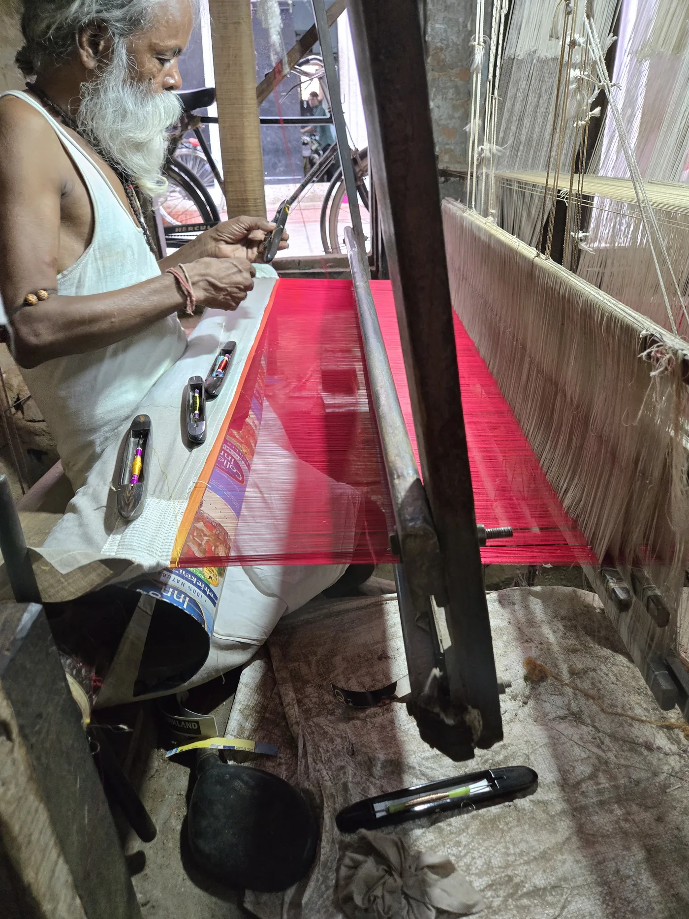 KashiFab Banarasi silk hand loom setup in Varanasi - weaver producing pink silk fabric wholesale