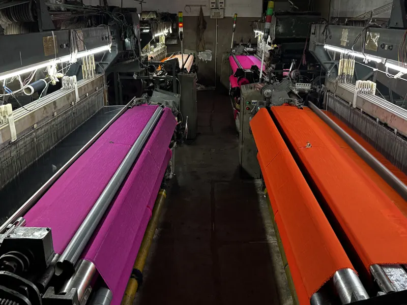 KashiFab Banarasi silk power loom weaving magenta and orange fabric in Varanasi manufacturing