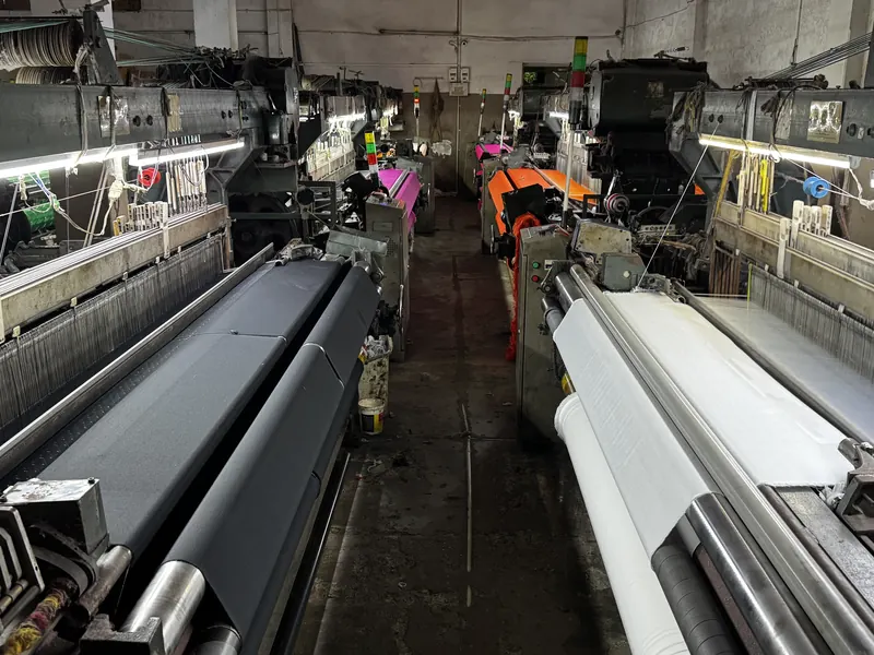 KashiFab Banarasi silk power loom setup in Varanasi - factory aisle weaving fabric wholesale
